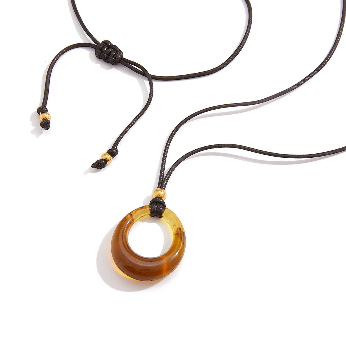 Amber-colored resin long necklace with a black cord. Vera Lux