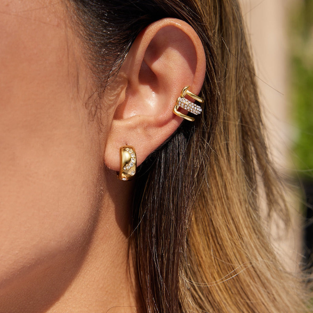 18K gold earrings inlaid with cubic zirconia, in a nail design. Vera Lux