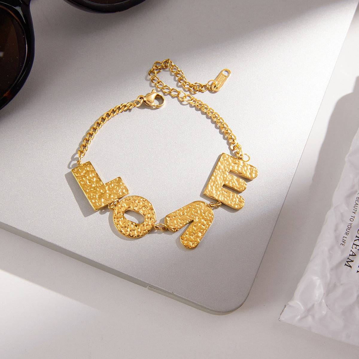 18K gold-plated, lightweight, and luxurious titanium steel bracelet with letter design. Vera Lux