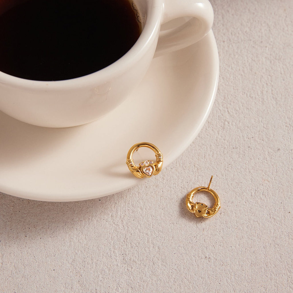 18K gold-plated friendship hand design titanium steel stud earrings with cubic zirconia. Vera Lux