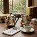 Pure 999 Fine Silver Hand-Hammered Silver Teapot and Creamer Set with Sleek Black Handles and Warm Metallic Accents - Handicraft Vera Lux