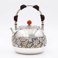 Pure 999 Fine Silver Elegant Hammered Silver Teapot with Intricate Floral Relief and Woven Handle - Handicraft Vera Lux