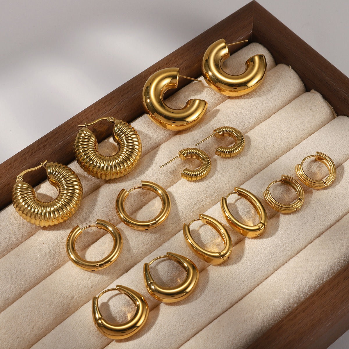 18K gold-plated, lightweight, and luxurious titanium steel stud earrings. Vera Lux