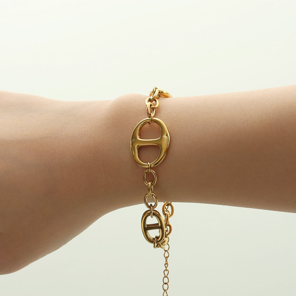 18K gold geometric-shaped necklace, bracelet, and earrings set. Vera Lux