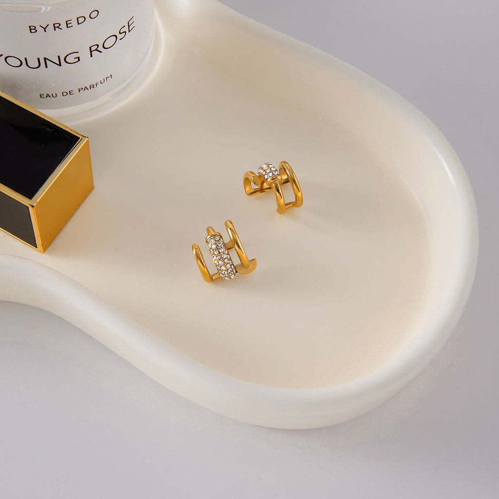 18K gold earrings inlaid with cubic zirconia, in a nail design. Vera Lux
