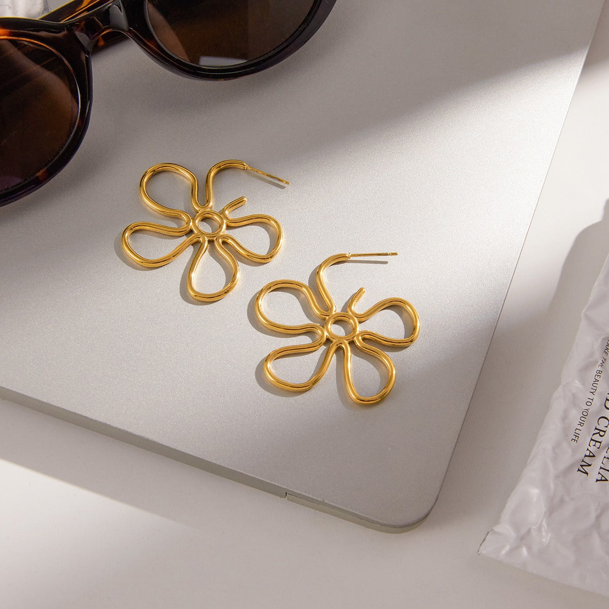 18K gold-plated, lightweight, and luxurious flower-shaped titanium steel earrings. Vera Lux