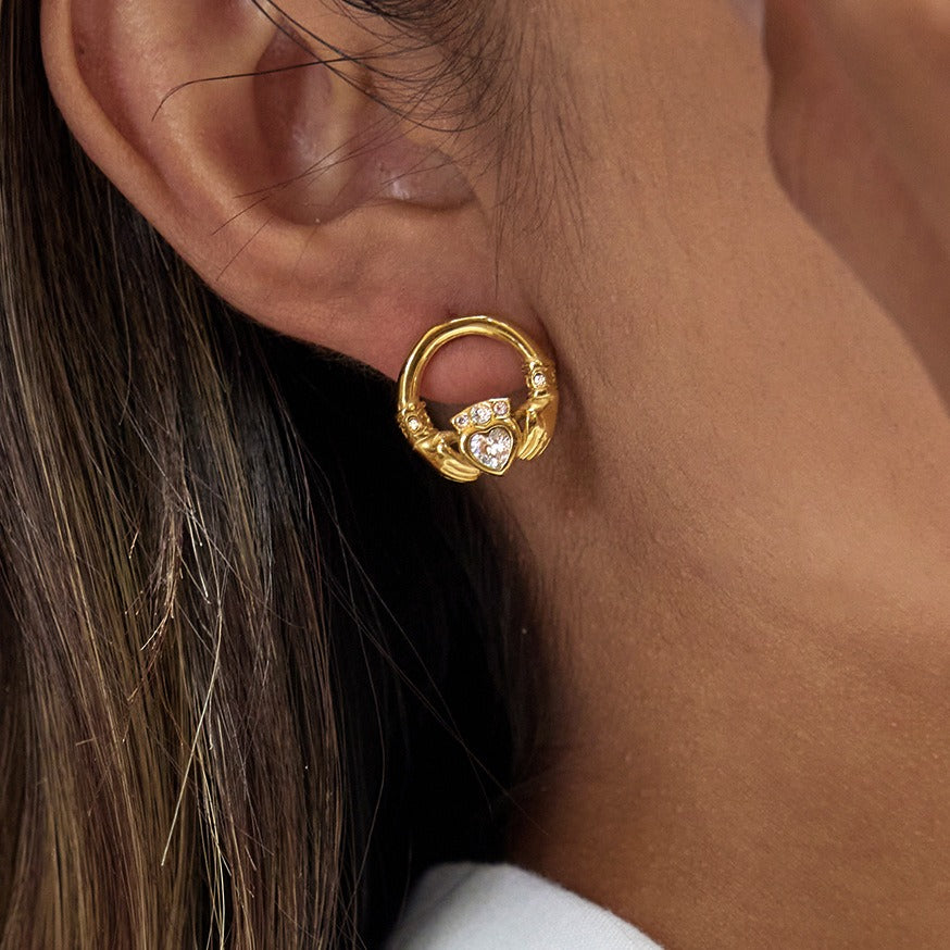 18K gold-plated friendship hand design titanium steel stud earrings with cubic zirconia. Vera Lux