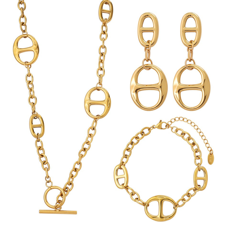 18K gold geometric-shaped necklace, bracelet, and earrings set. Vera Lux
