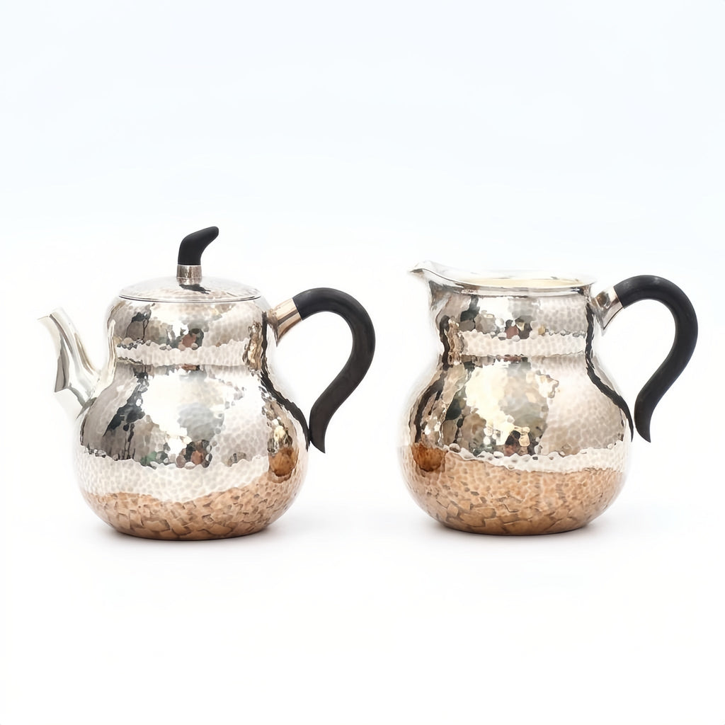 Pure 999 Fine Silver Hand-Hammered Silver Teapot and Creamer Set with Sleek Black Handles and Warm Metallic Accents - Handicraft Vera Lux