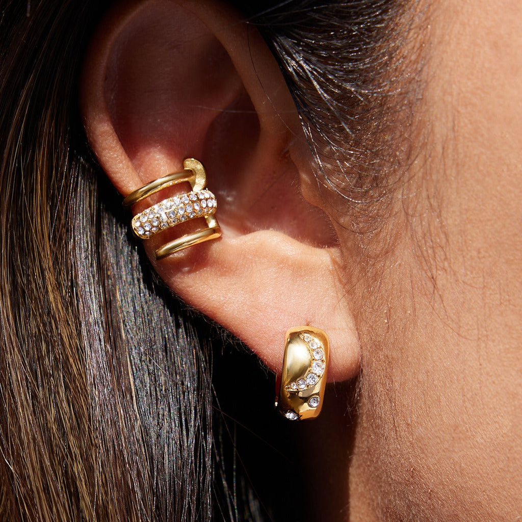 18K gold earrings inlaid with cubic zirconia, in a nail design. Vera Lux