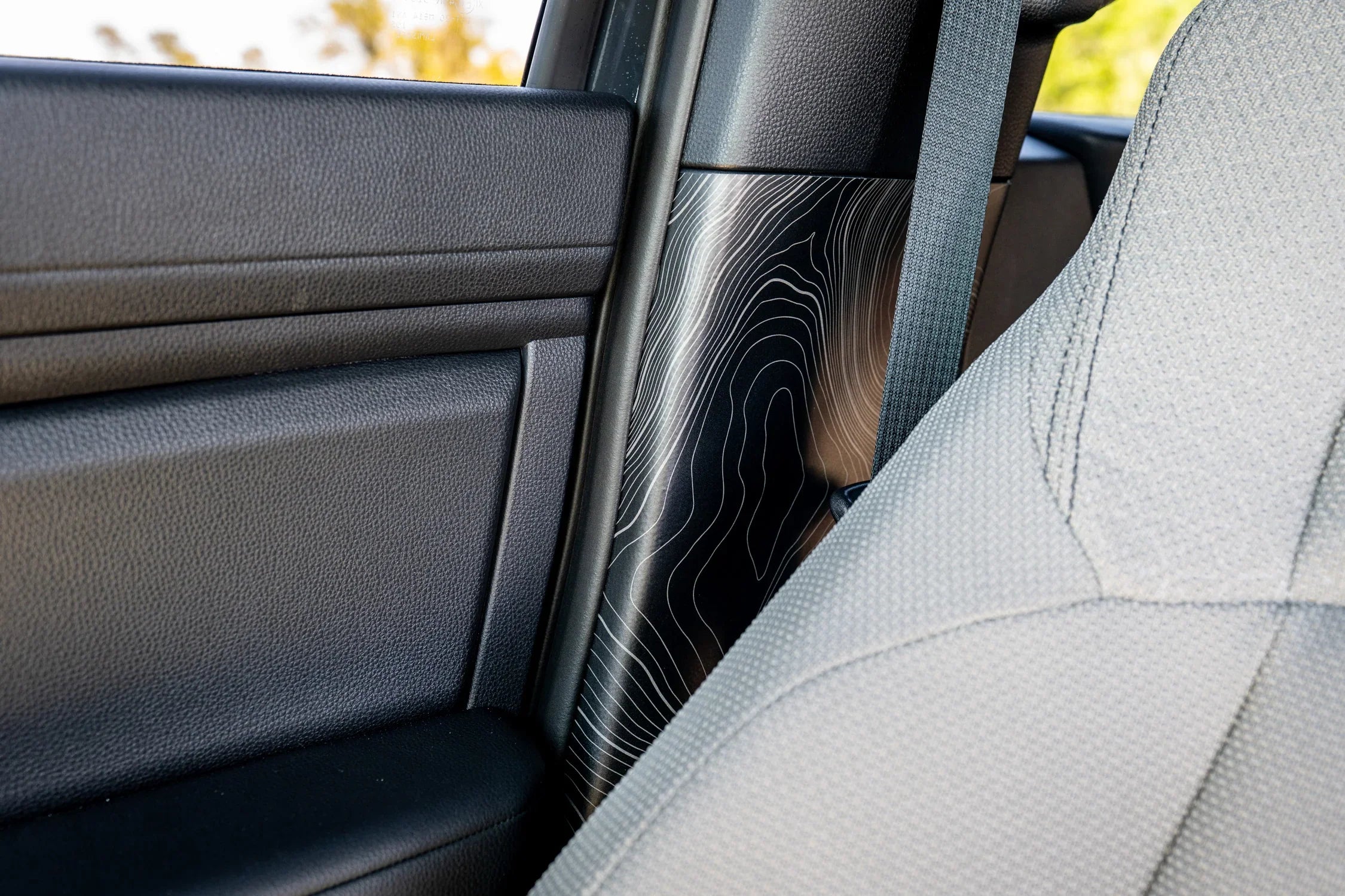Topographic Seatbelt Panel Protection - 2024+ Tacoma / 2025+ 4Runner StickerFab
