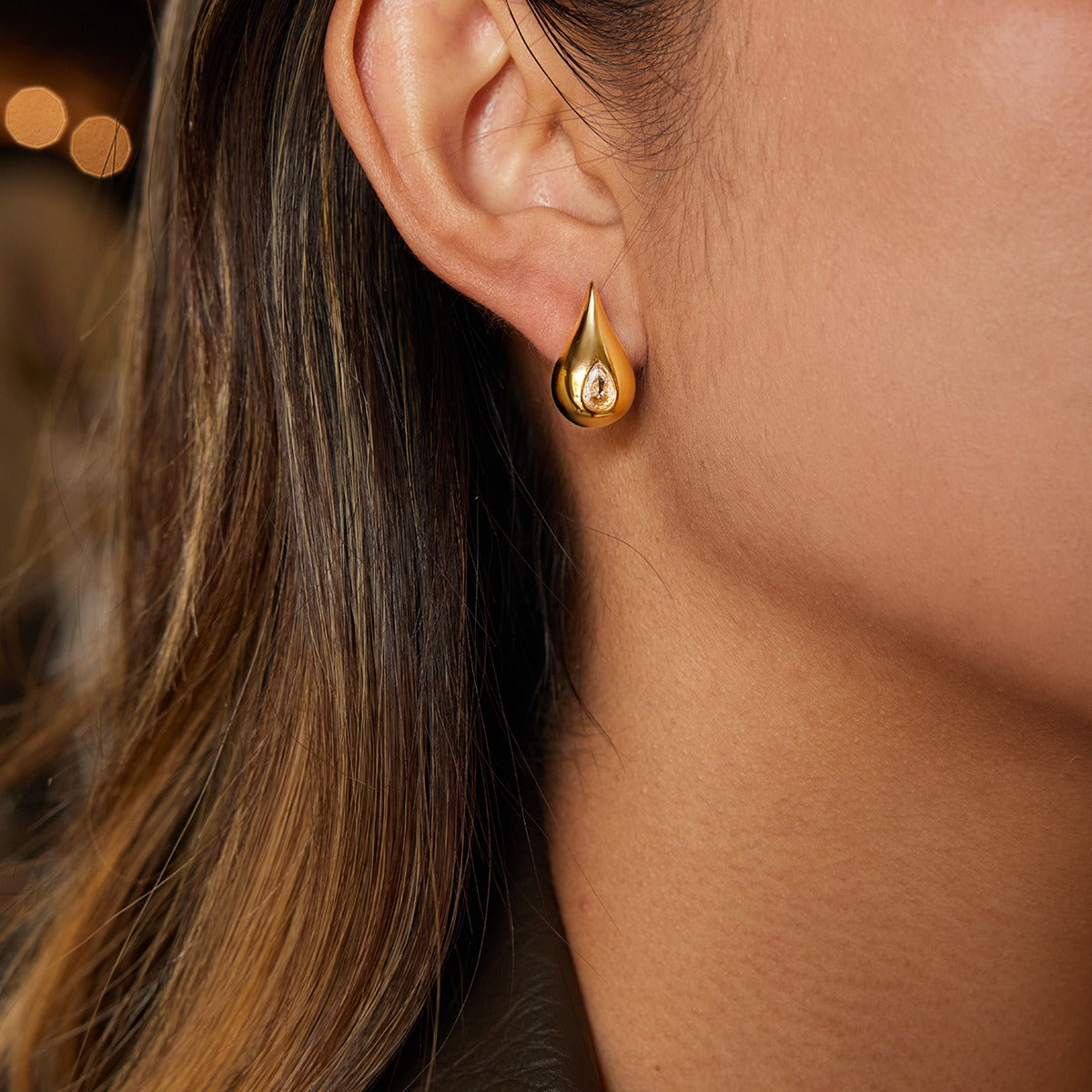 18K gold earrings inlaid with cubic zirconia in a teardrop design. Vera Lux