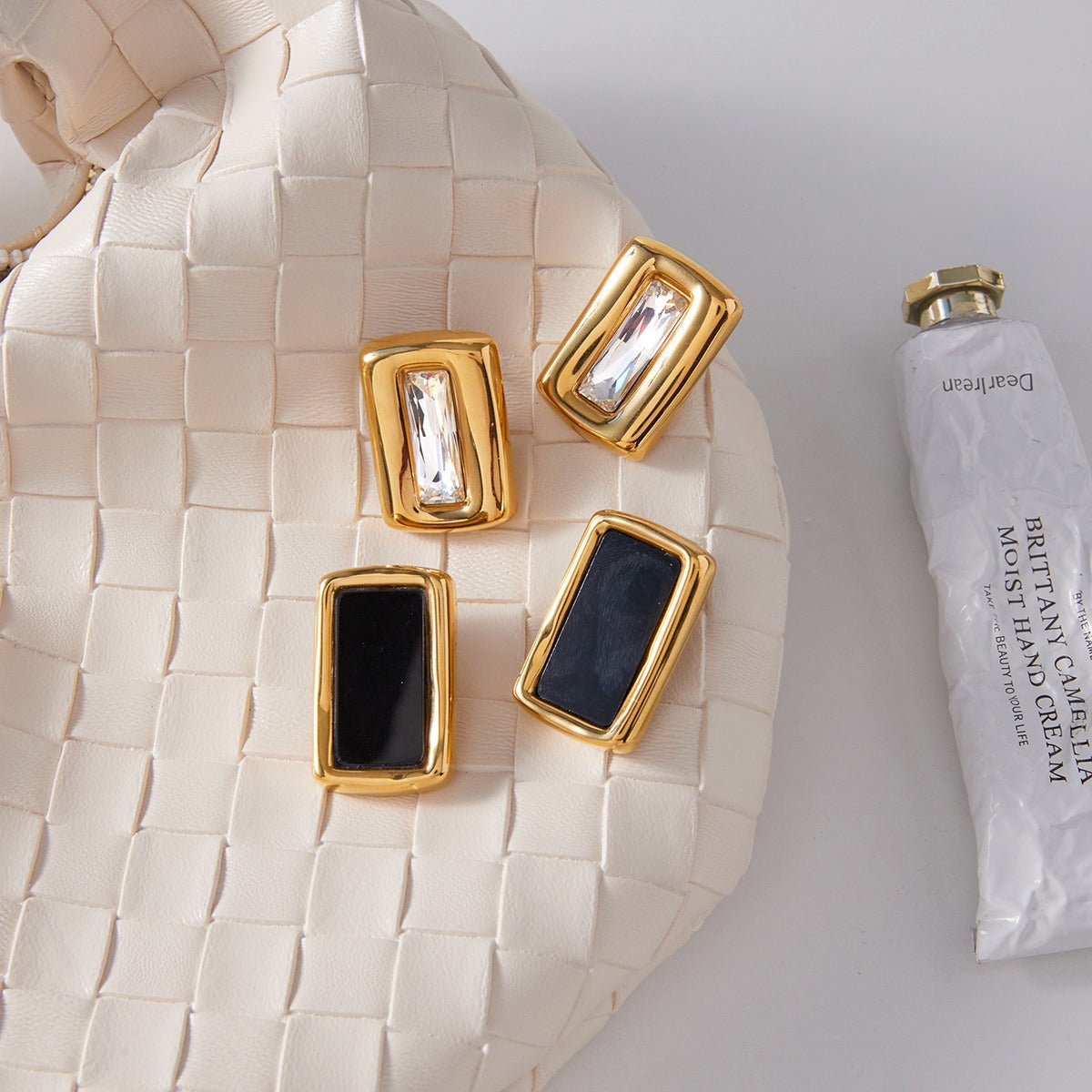 18K gold, black acrylic, and titanium steel stud earrings. Vera Lux