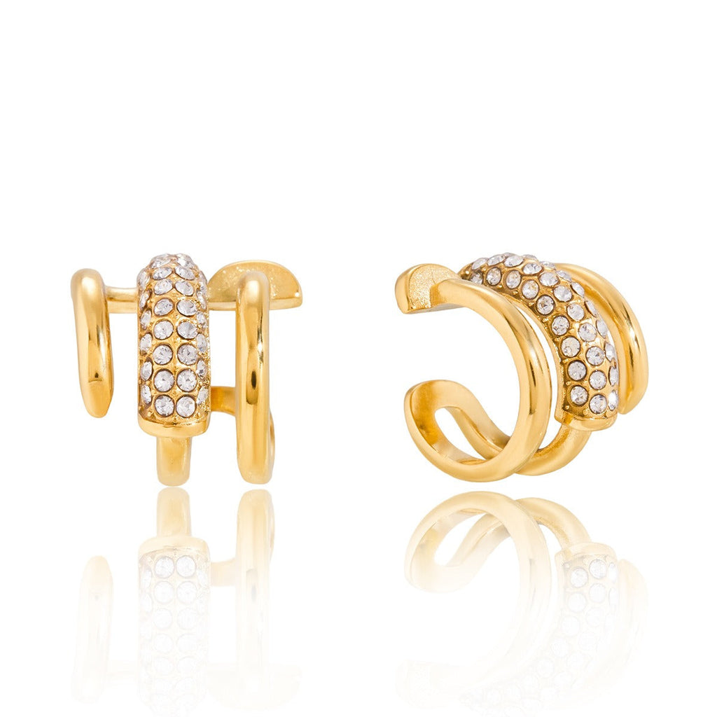18K gold earrings inlaid with cubic zirconia, in a nail design. Vera Lux