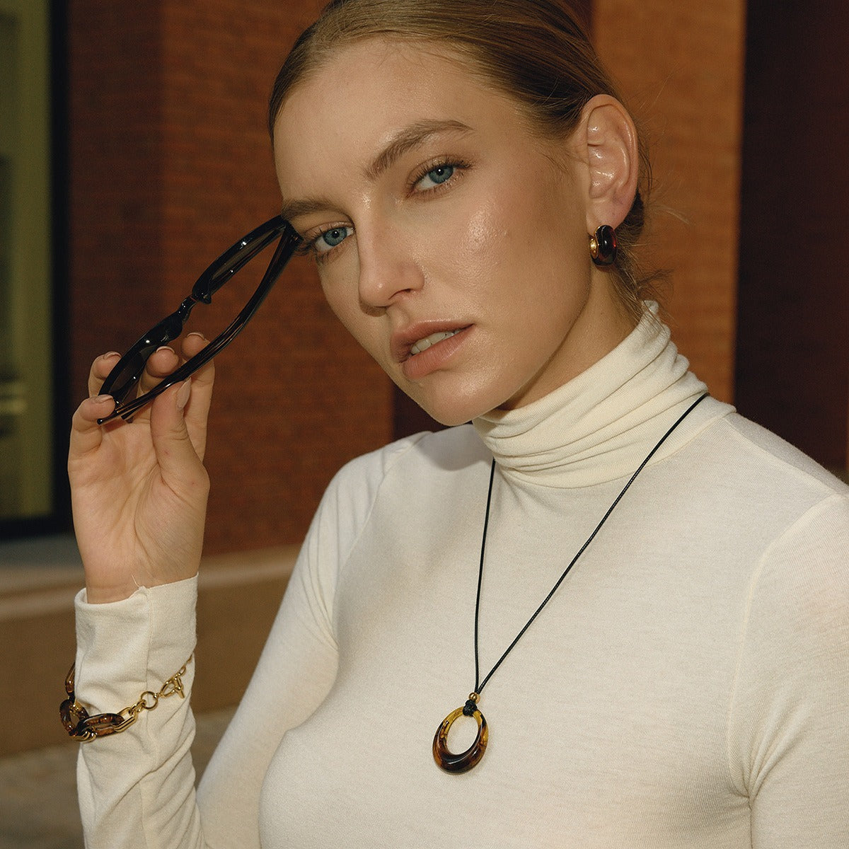 Amber-colored resin long necklace with a black cord. Vera Lux